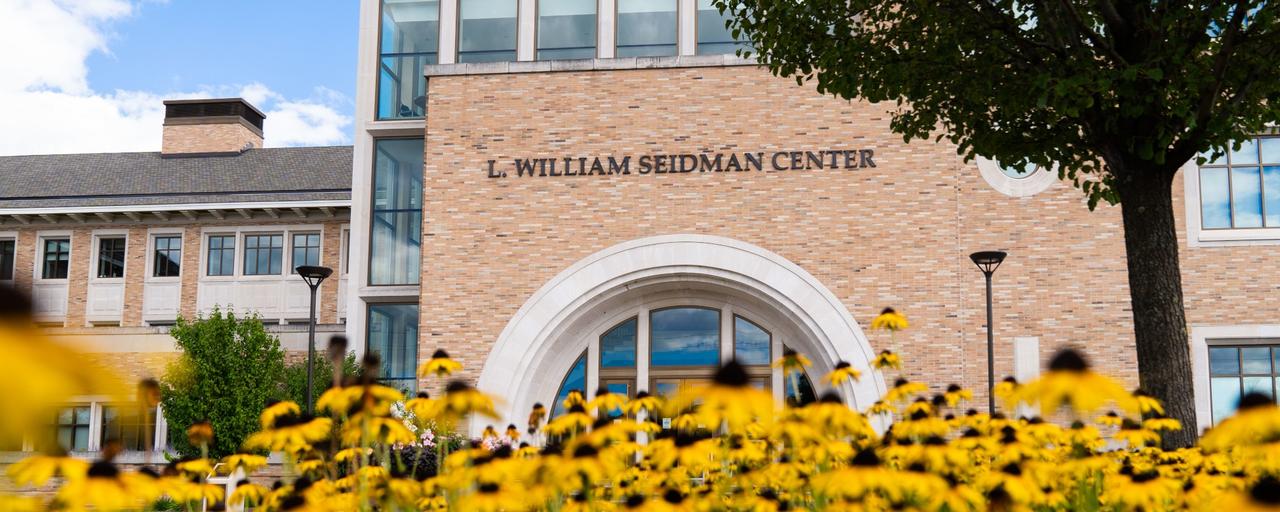 GVSU Seidman Center with yellow flowers